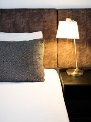 hotel-bed-with-bedside-lamp-2021-04-05-20-51-10-utc-683x1024